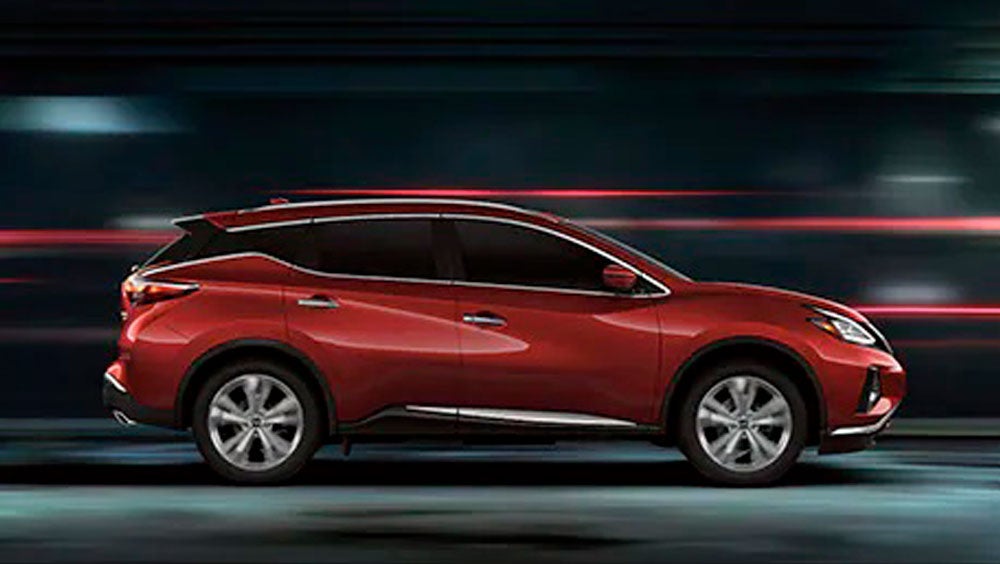 2023 Nissan Murano shown in profile driving down a street at night illustrating performance. | Redwood City Nissan in Redwood City CA