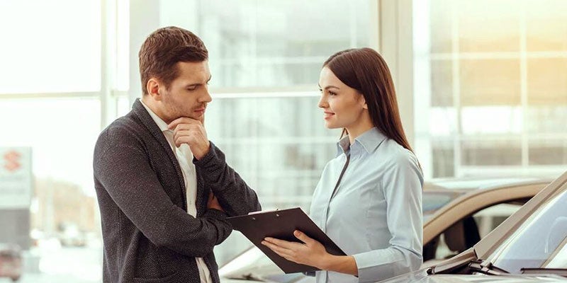 Car shopper talking with dealership salesperson